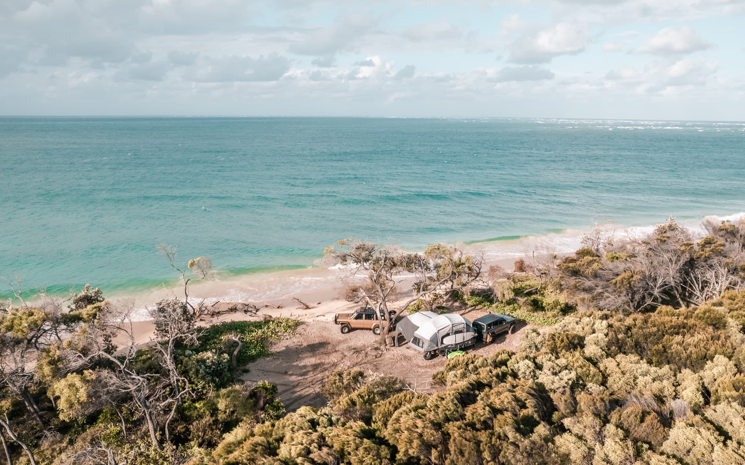 OPUS OP4 camper set up on a turquoise Western Australia coastline